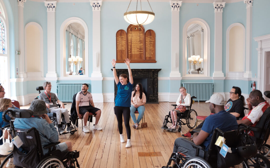 A CoDa dancer leads a Dance for Neurology session in a beautiful hall at Royal Hospital for Neurology